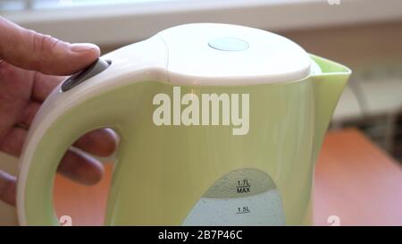 Turn on the electric kettle. Water boils. The temperature sensor is triggered. Auto power off Stock Photo
