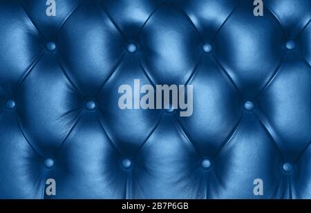 Dark blue capitone genuine leather background, classic retro Chesterfield style soft tufted furniture upholstery with deep diamond pattern and buttons Stock Photo