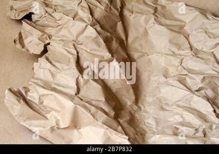 Two states of wrapping paper. Used and new packaging paper. Ambiguous abstraction. Close-up. Selective focus. Stock Photo