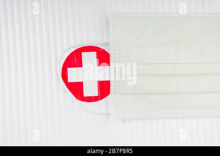 Medical masks on first aid kit box with red cross, protection concept Stock Photo