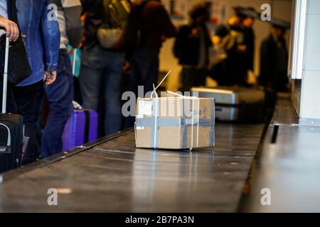 Otopeni, Romania - February 25, 2020: Cardboard box luggage on the baggage carousel in an international airport. Stock Photo