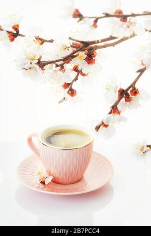 Happy Easter concept. Congratulatory easter background. Cup of coffee and sakura branches on a white background Stock Photo