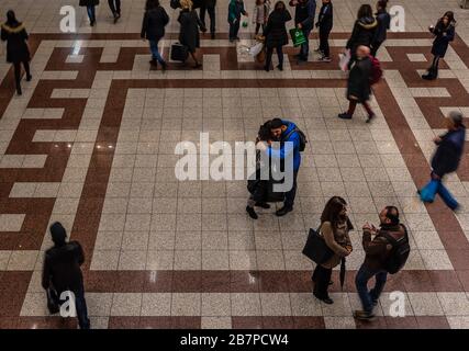 Athens, Attica / Greece - 12 26 2019: A young man and woman hugging for goodbye in the Syntagma metro station Stock Photo