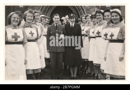 WW2 era photo of happy attractive British Red Cross military nurse officer VAD in service uniform wearing a British Red Cross Society cap badge, on a cap -  marrying an RAF airman, Bristol, England, U.K. dated January 1944 Stock Photo