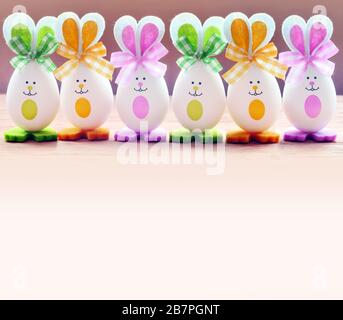 Group Easter eggs with the Bunny ears on pink background. Easter concept. Stock Photo
