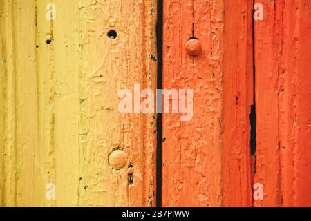 Close-up of a gradient yellow and red colored board with cracks from old age. Stock Photo