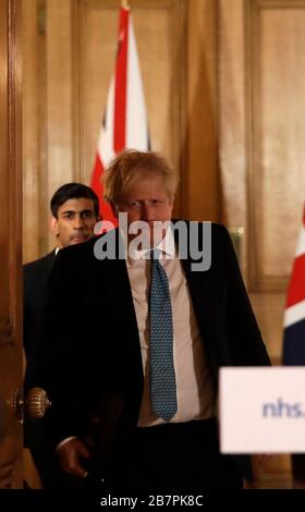 Chancellor Rishi Sunak with Prime Minister Boris Johnson arrive for a media briefing in Downing Street, London, on Coronavirus (COVID-19). Picture date: Tuesday March 17, 2020. See PA story HEALTH Coronavirus. Photo credit should read: Matt Dunham/PA Wire Stock Photo