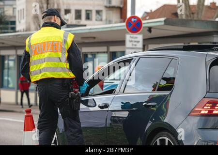 Kehl, Germany - Mar 16, 2020: officer of the Bundespolizei checks traffic at the border crossing in Kehl from France Strasbourg during crisis measures in the fight against the novel coronavirus. Stock Photo