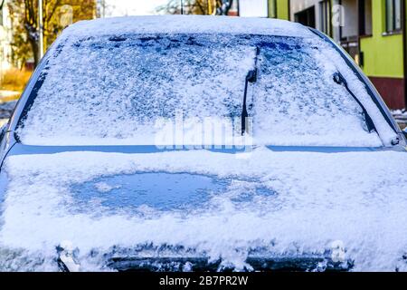 car in winter, snow and ice on the windscreen, frozen glass wiper Stock Photo