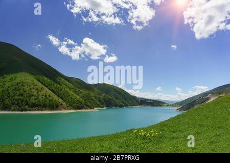 Bright Sunny day near the beautiful mountain lake Kezenoi am in Vedensky district, Chechen Republic. Juicy greens in early summer. Russia, North Cauca Stock Photo