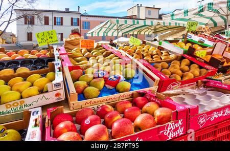 Faenza, Italy - February 27, 2020:  Market stall with apples and pears at street market in Faenza in Italy Stock Photo