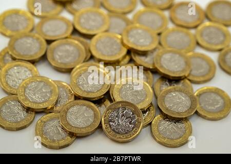 LONDON, UK - JANUARY 2020: Close up view of British currency Great British Pound GBP - One Pound coin leaning on other coins blurred in the background Stock Photo