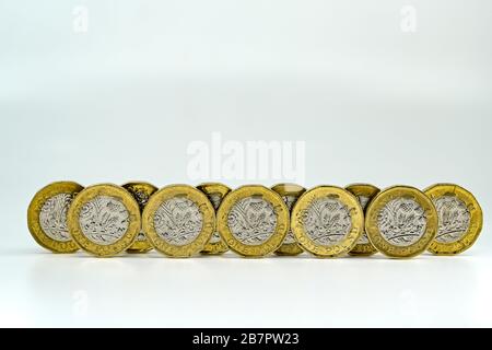 CARDIFF, WALES - JANUARY 2020: Close up view of British currency GBP - One Pound coins on a plain white background Stock Photo