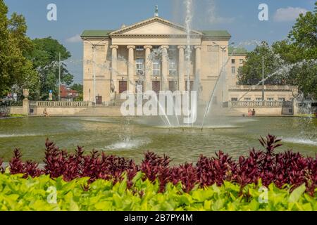 The front of the Grand Theater in Poznan. The pond and fountain of the Mickiewicza park can be seen in the foreground. Stock Photo