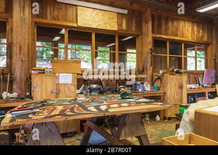 Totem carving workshop at Saxman Native Village Dance Performance and Totem Park cruise ship excursion in Ketchikan, Alaska. Stock Photo