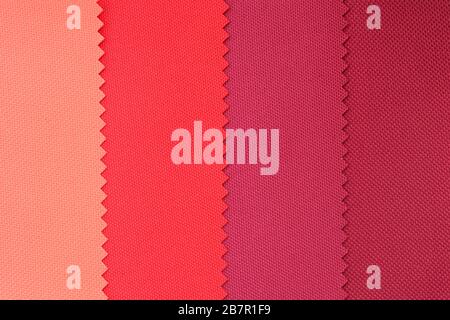 Samples of fabrics in pastel colors. red and pink piece of fabric with texture. Lightweight fabric made of synthetic fibres (nylon or polyester) of a Stock Photo