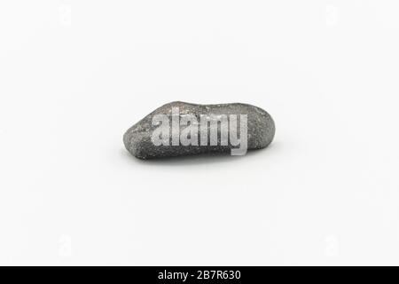 Black magnetic Atacaimite Tektite Meteorite isolated, a rock formed in a big meteorite collision at Atacama Desert. Amazing fusion textures over the s Stock Photo