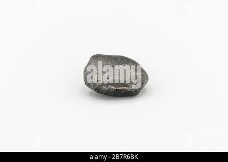 Black magnetic Atacaimite Tektite Meteorite isolated, a rock formed in a big meteorite collision at Atacama Desert. Amazing fusion textures over the s Stock Photo