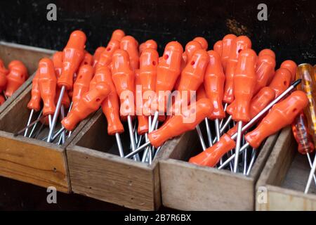 Screwdrivers at checkout in front of the store. Our red handle is stalked. It is unused and new. Close up. Stock Photo
