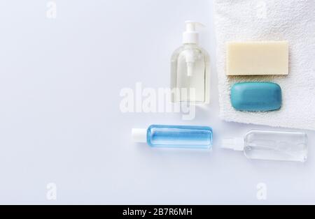 Coronavirus protection hand hygiene. Many hand sanitizer bottles on white table. Alcohol gel antibacterial soap sanitizer, hands disinfection. Hygiene Stock Photo