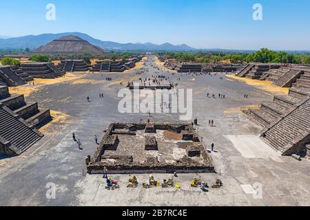 The archaeological site of Teotihuacan seen from the moon pyramid with the Alley of the Dead and Sun Pyramid and tourists, Mexico City, Mexico.