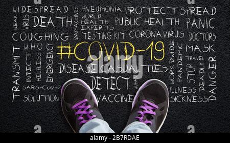 Person standing on asphalt with # COVID-19 word cloud. Concept of worldwide coronavirus pandemic. Stock Photo