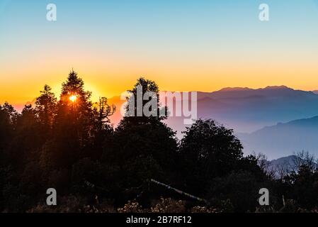 Stacked mountain ridges seen during golden hour of sunset from Poonhill Ghorepani Nepal Stock Photo