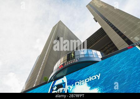 New York City/USA - May 24, 2019  New York Marriott Marquis Hotel, located on West 46th Street and Broadway. Low angle view with cloudy sky background Stock Photo