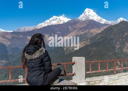 Beautiful girl posing infront of Dhaulagiri mountain range, Pokhara, Nepal Stock Photo