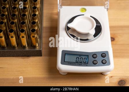 Production of cartridges for a rifle, reload. Empty shells and gunpowder scales Stock Photo