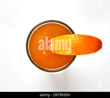 Highball tall glass of unfiltered white beer with a slice of orange over white background. Beer is one of the oldest, most popular and widely consumed Stock Photo