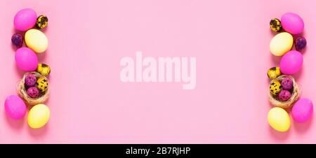Happy easter concept. Colored eggs lie in a row on a pink background. Copy space flat layout. Banner with place for text advertising. Stock Photo