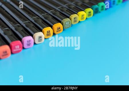 Multi-colored markers on a blue background. Marker for drawing and creativity. Stock Photo