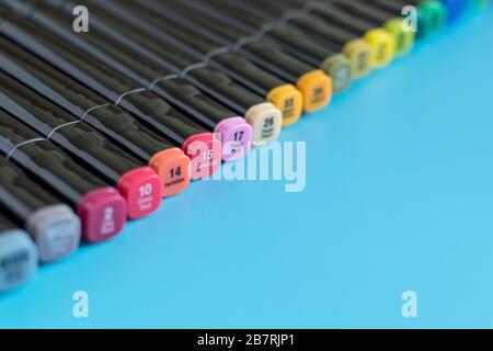 Multi-colored markers on a blue background. Marker for drawing and creativity. Stock Photo