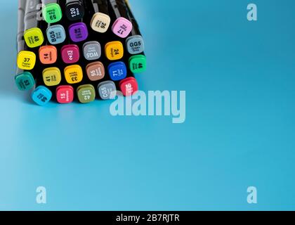 Multi-colored markers on a blue background. Marker for drawing and creativity . Stock Photo