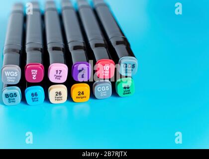 Multi-colored markers on a blue background. Marker for drawing and creativity . Stock Photo