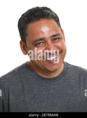 A smiling Indian man in a studio against a white background Stock Photo