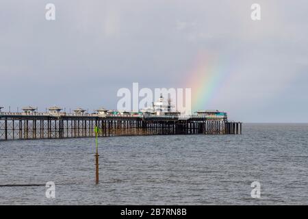 Rainbow over Llandudno Pier on the North Wales coast Stock Photo