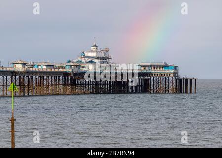 Rainbow over Llandudno Pier on the North Wales coast Stock Photo