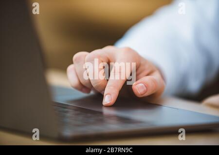 woman hand on laptop touchpad close up Stock Photo