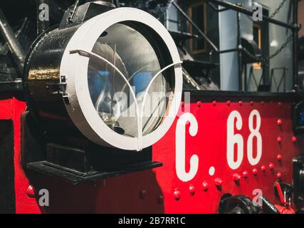 Round headlight of old retro vintage steam train at railway museum Stock Photo