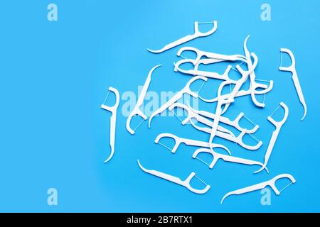 White floss toothpicks on blue background. Copy space Stock Photo