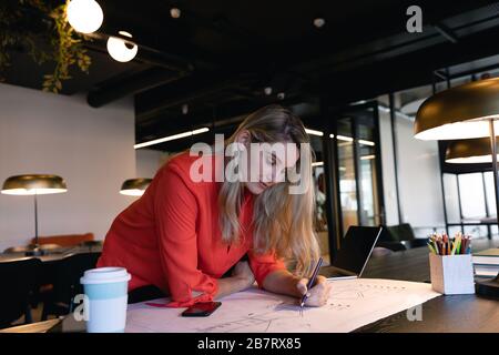 Architect Caucasian woman working on her sketches Stock Photo