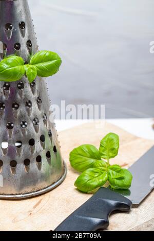 Basil leaveson a desk with a notebook for recipes and notes a composition with negative space a background for advertsing Stock Photo