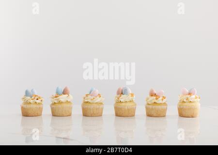Delicious easter cupcakes isolated on grey Stock Photo