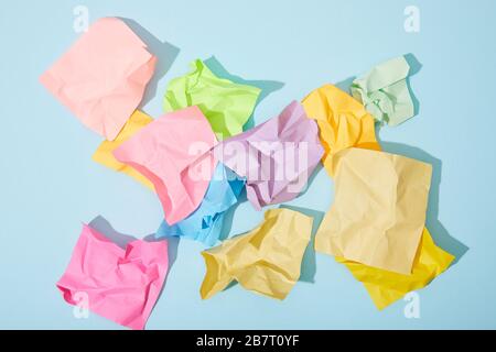 Blue crumpled sticky notes blank with drawing sad face on black ...