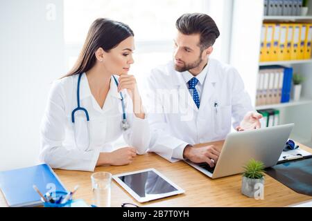 Photo of two doctors together discussing new way of treatment while having a meeting at office Stock Photo