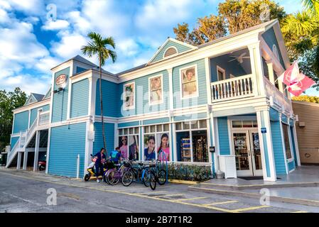 KEY WEST, FL - FEBRUARY 20, 2016: Tourists walk along city streets at sunset. Key West is the main city of Keys Islands. Stock Photo