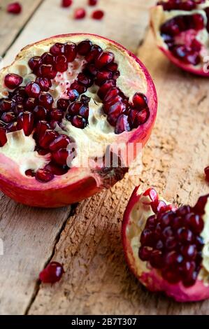 Juicy Ripe Pomegranate Fruit on Old Wooden Table. Stock Photo