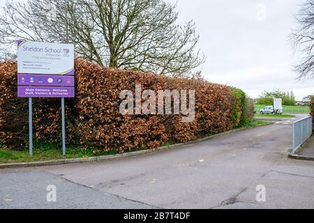 Chippenham, Wiltshire UK, 18th March, 2020. The entrance to Sheldon secondary school is pictured this morning as two large secondary schools in Chippenham, Wiltshire were closed to pupils.Hardenhuish and Sheldon schools announced on Tuesday that they would not open on Wednesday because of the coronavirus outbreak.Following the government’s recent advice regarding people self-isolating and social distancing to delay the spread of the Coronavirus both schools had been left with significant staff shortages and said they would remain shut until further notice. Credit: Lynchpics/Alamy Live News Stock Photo